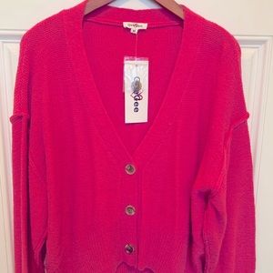 Bright pink cardigan.